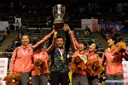 Members and coach of China's women's table tennis team pose with their trophy during the awarding ceremony of final against Japan at the 2016 World Team Championships in Kuala Lumpur, Malaysia, March 6, 2016. Defending champion China's women's table tennis team won the world championship title for the 20th time by defeating Japan 3-0 in the final. (Xinhua/Chong Voon Chung)