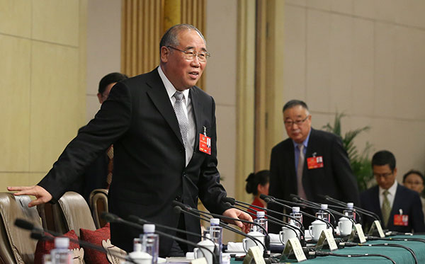 Xie Zhenhua, China's special representative on climate change, takes his seat at a news conference on the sidelines of the two sessions on Monday. KUANG LINHUA/CHINA DAILY
