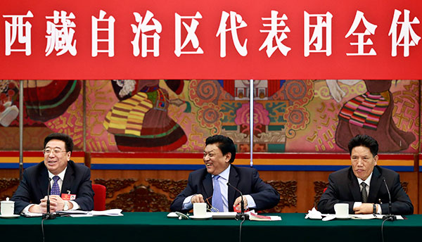 Padma Choling, head of the Standing Committee of the Tibet People's Congress (middle), Losang Jamcan, chairman of the autonomous region (right) and Wu Yingjie, deputy Party chief of the region, attend a panel discussion on Monday. FENG YONGBIN/CHINA DAILY