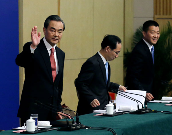 Chinese Foreign Minister Wang Yi greets reporters at a press conference in Beijing March 8, 2016. (Kuang Linhua/China Daily)
