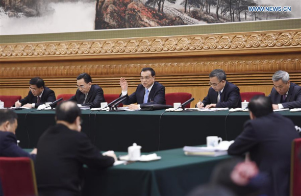 Chinese Premier Li Keqiang (C, back) joins a group deliberation of deputies from Guangdong Province to the annual session of the National People's Congress in Beijing, capital of China, March 9, 2016. (Photo: Xinhua/Li Xueren)