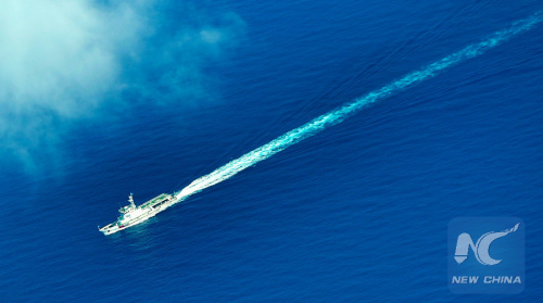 An aerial photo taken on Sept. 25, 2015 from a seaplane of Hainan Maritime Safety Administration shows cruise vessel Haixun 1103 heading to the Yacheng 13-1 drilling rig during a patrol in south China Sea. (Xinhua/Zhao Yingquan)