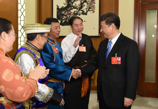 President Xi Jinping meets deputies from various ethnic groups while attending a panel discussion with the Qinghai province delegation during the annual sessions of the top legislature and political advisory body in Beijing on Thursday. (Photo: Xinhua/Huang Jingwen)
