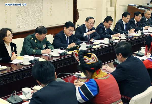 Yu Zhengsheng (4th L, back), chairman of the National Committee of the Chinese People's Political Consultative Conference, joins a group deliberation of deputies from Yunnan Province to the annual session of the National People's Congress in Beijing, capital of China, March 11, 2016. (Xinhua/Yao Dawei)