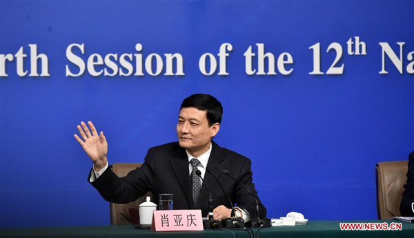 Xiao Yaqing, chief of the State-owned Assets Supervision and Administration Commission of the State Council (SASAC) greets journalists at a press conference on the reform of state-owned enterprises on the sidelines of the fourth session of the 12th National People's Congress in Beijing, capital of China, March 12, 2016. (Xinhua/Zhao Yingquan)