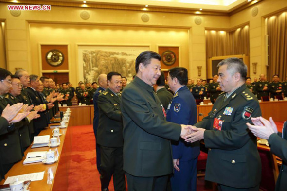 Chinese President Xi Jinping, also general secretary of the Communist Party of China Central Committee and chairman of the Central Military Commission, shakes hands with deputies to the 12th National People's Congress (NPC) from the People's Liberation Army (PLA) as he attends a plenary meeting of the PLA delegation to the NPC during the ongoing annual parliamentary session held in Beijing, capital of China, March 13, 2016.(Photo: Xinhua/Li Gang)