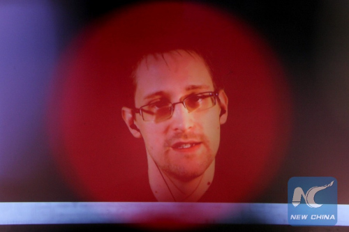 Edward Snowden is seen on the screen during a live remote interview at CeBIT 2015, the world's top trade fair for information and communication technology, in Hanover, Germany, on March 18, 2015. (Xinhua/Zhang Fan/File Photo)