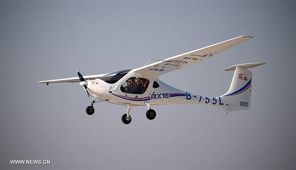 File photo taken on Feb 6, 2015 shows a two-seater electric aircraft RX1E flying in Shenyang, northeast China's Liaoning Province. After the test flights in low temperatures, RX1E has been put into production recently. The domestically developed electric aircraft has a 14.5-meter wingspan and a maximum payload of 230 kg. It can fly at an altitude of 3,000 meters. (Photo/Xinhua)