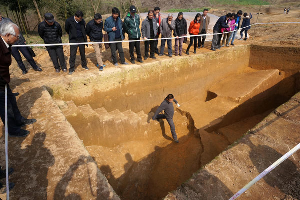 An archaeologist examines sections of unearthed ancient flood-control dams in Hangzhou, Zhejiang province. Wu Huang/for China Daily