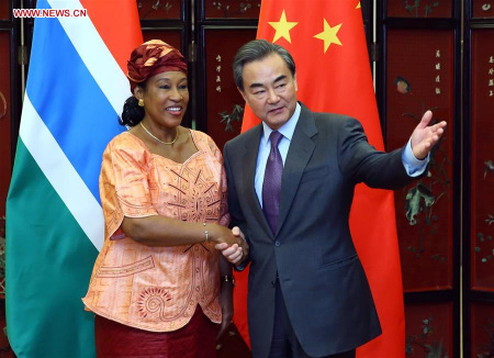 Chinese Foreign Minister Wang Yi (R) holds talks with his Gambian counterpart Neneh MacDouall Gaye in Beijing, capital of China, March 17, 2016. (Xinhua/Ding Haitao)