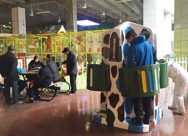 A man uses an open-air urinal at Foreigner Street, a free-entry urban amusement park in Chongqing.(Photo: China Daily/Deng Rui)
