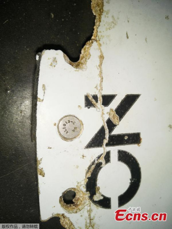 Possible debris from missing Malaysia Airlines Flight MH370 has been found off Mozambique on a sandbank in the Mozambique Channel  the body of water between Mozambique in eastern Africa and Madagascar. The object has the words NO STEP on it and could be from the plane's horizontal stabilizer  the wing-like parts attached to the tail, sources say. It was discovered by an American who has been blogging about the search for MH370.(Photo provided to China News Service)