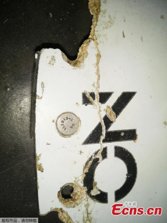 Possible debris from missing Malaysia Airlines Flight MH370 has been found off Mozambique on a sandbank in the Mozambique Channel �� the body of water between Mozambique in eastern Africa and Madagascar. The object has the words NO STEP on it and could be from the plane's horizontal stabilizer �� the wing-like parts attached to the tail, sources say. It was discovered by an American who has been blogging about the search for MH370.(Photo provided to China News Service)