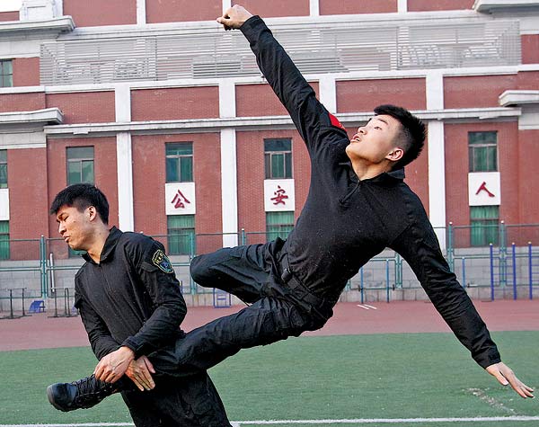 Students majoring in counterterrorism at the People's Public Security University of China attend a physical combat training session. Zhang Wei / China Daily