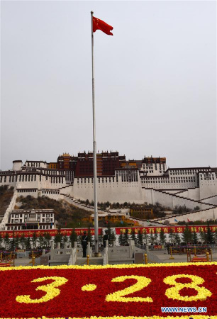 A flag-raising ceremony is held to celebrate the Serfs' Emancipation Day at the Potala Palace square in Lhasa, southwest China's Tibet Autonomous Region, March 28, 2016. In 2009, March 28 was designated as the day to mark the freeing of 1 million people, or 90 percent of the region's population at that time, from the feudal serf system in 1959. (Xinhua/Chogo)