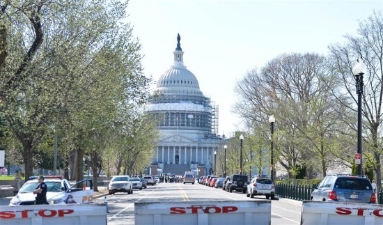 Police block the area near the U.S. Capitol Building after a shooting incident in Washington D.C., the United States, March 28, 2016. The U.S. Capitol Hill and the White House were both on lockdown Monday afternoon after a shooting incident at the Visitors Center of the Capitol complex left a police injured. (Xinhua/Bao Dandan)