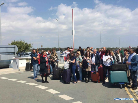 Passengers wait for a bus to Paphos at the Larnaca airport in Larnaca, Cyprus, March 29, 2016. The women and children on a hijacked Egyptian plane have been released after it landed in Larnaca, Cyprus, Cypriot authorities said Tuesday. Larnaca airport has been closed and arriving planes are being redirected to Paphos in western Cyprus. (Photo: Xinhua/Zhang Zhang) 