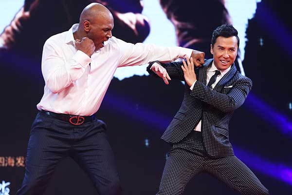 Donnie Yen and former boxing champion Mike Tyson pose as if fighting at a promotional event for Ip Man 3 in Beijing. (Photo provided to China Daily)