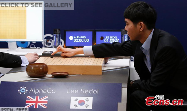 South Korean professional Go player Lee Sedol puts a stone against Google's artificial intelligence program, AlphaGo, as Google DeepMind's lead programmer Aja Huang sits during the match in Seoul on Wednesday.(Photo/Agencies)