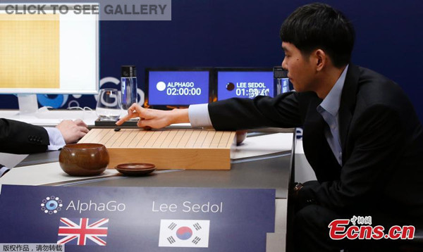 South Korean professional Go player Lee Sedol puts a stone against Google's artificial intelligence program, AlphaGo, as Google DeepMind's lead programmer Aja Huang sits during the match in Seoul on Wednesday.