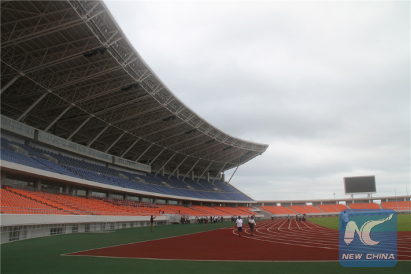 People walk inside Mozambique's national stadium in Maputo, capital of Mozambique, Jan. 17, 2011. The newly-completed stadium, which is sponsored by the Chinese government, occupies an area of nearly 270,000 square meters. With a floor space of 42,000 square meters, the stadium has as many as 42,000 seats. (Xinhua File Photo/Liu Dalong)