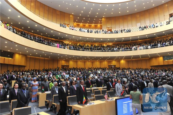 Guests stand up in the national anthem of the People's Republic of China during the inauguration ceremony of the new Conference Center for the African Union (AU) in Addis Ababa, capital of Ethiopia, Jan. 28, 2012. The new Conference Center for the AU, which is sponsored by the Chinese government, was inaugurated here on Saturday. Jia Qinglin, chairman of the National Committee of the Chinese People's Political Consultative Conference, attended the inauguration ceremony and gave a speech. (Xinhua File Photo/Rao Aimin)