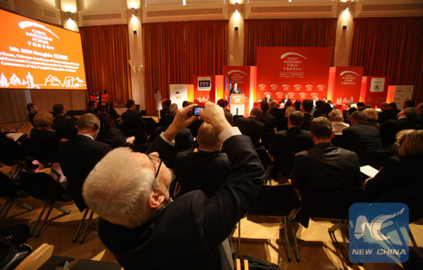 A delegate takes pictures while attending the China Investment Forum, in Prague, capital of the Czech Republic, on Nov. 8, 2011. (Xinhua)