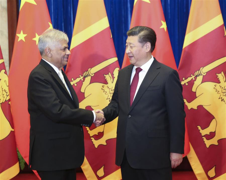 Chinese President Xi Jinping (R) shakes hands with Sri Lankan Prime Minister Ranil Wickremesinghe in Beijing, China, April 8, 2016. (Xinhua/Ding Lin)