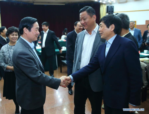 Liu Qibao (L, front), head of the Publicity Department of the Communist Party of China (CPC) Central Committee, shakes hand with Chinese children's fiction writer Cao Wenxuan (R, front), winner of the Hans Christian Andersen Prize 2016, after a symposium on the Chinese children's literature in Beijing, capital of China, April 12, 2016. (Xinhua/Ding Haitao)