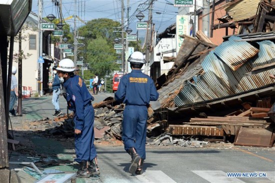 Firefighters check the buildings in the earthquake rocked Mashiki in Kumamoto prefecture, Japan, April 17, 2016. A powerful magnitude-7.3 earthquake struck the island of Kyushu in southwestern Japan early Saturday just a day after a sizable foreshock hit the region, with the number of fatalities now standing at 41 according to the latest figures on Sunday. (Xinhua/Ma Ping)