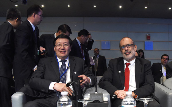 Finance Minister Lou Jiwei (left) with fellow participants at the inaugural Global Infrastructure Forum in Washington on Saturday. Yin Bogu / Xinhua