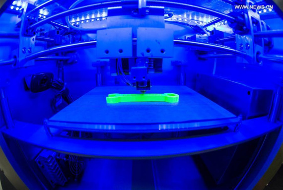 A micro-g 3D printer produces a plastic wrench at a research center in southwest China's Chongqing Municipality, April 19, 2016. The Research Center for Additive Manufacturing (3D Printing) Technology of Chongqing Institute of Green and Intelligent Technology announced on Tuesday that the first micro-g 3D printer was successfully developed. (Photo: Xinhua/Liu Chan) 