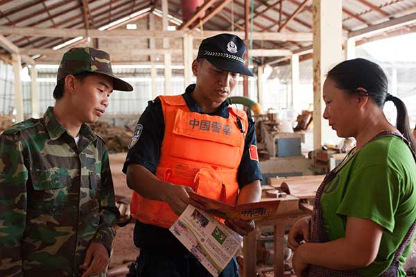 Chinese police provide anti-drug information to local people in Laos during a joint campaign in June.Lyu Shuai / Xinhua