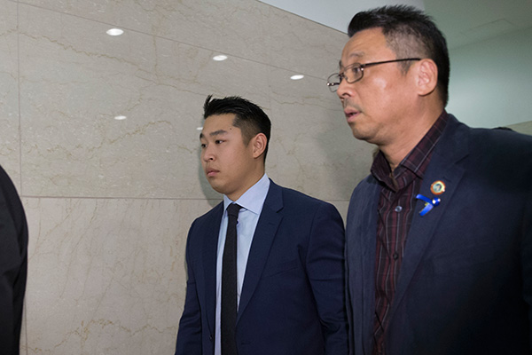 Peter Liang, left, walks out the court after the judge sentenced him to five years of probation and 800 hours of community service. PROVIDED TO CHINA DAILY