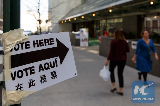 A sign reads Vote Here is seen outside a polling station in Manhattan, New York, April 19, 2016. New York's presidential primary kicked off on Tuesday. (Xinhua/Li Muzi)