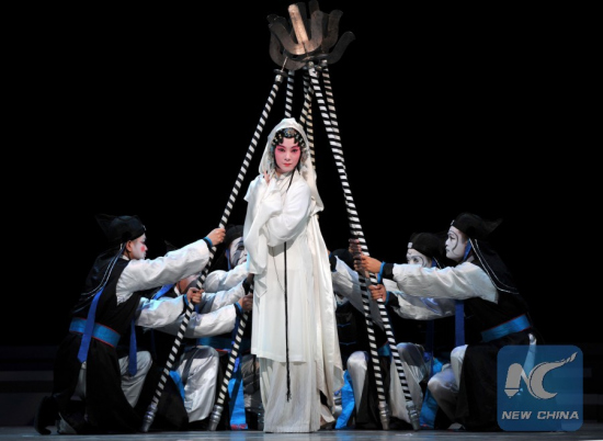 Actors perform traditional Kunqu Opera Peony Pavilion during the 10th China Art Festival in Jinan, capital of east China's Shandong Province, Oct. 18, 2013. Peony Pavilion, created by ancient Chinese playwriter Tang Xianzu (1550-1616), tells a love story between Du Liniang and Liu Mengmei, embodying young people's pursuit of love and freedom. (Photo: Xinhua/Xu Suhui)