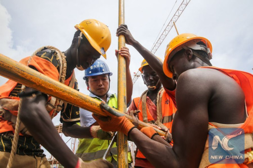 Chinese engineer Zhang Qingchun (2nd L) works with his Kenyan colleagues at a constructing site of the Mombassa West Station under a standard gauge railway (SGR) project, in Mombassa, Kenya, on April 9, 2016. (Photo: Xinhua/Pan Siwei)
