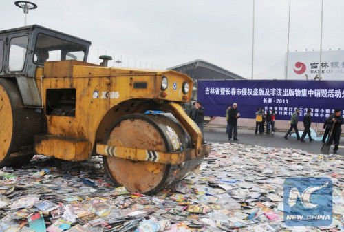 Photo taken on April 22, 2011 shows that the pirated and illegal publications and audio-visual products are destroyed in Changchun, capital of northeast China's Jilin Province. (Photo: Xinhua/Chang Yishu)