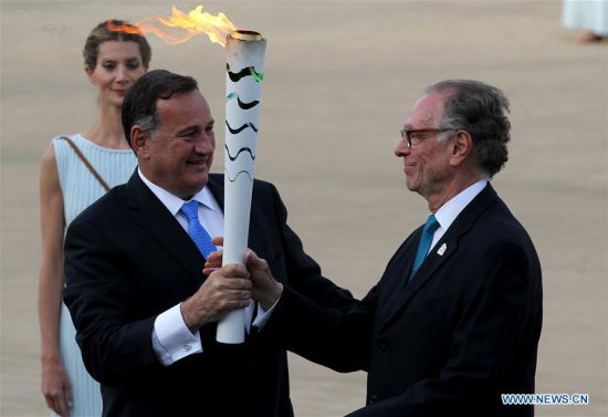 Carlos Nuzman(R), the President of the Organizing Committee for the RIO 2016 Olympic Games, receives the torch from Spyros Capralos, the President of HOC (Hellenic Olympic Committee), during the handover ceremony at Panathenaic Stadium in Athens, April 27, 2016. (Photo: Xinhua/Marios Lolos)
