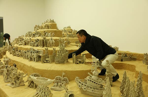 Farmer-turned-artist Hu Zhijun's clay figurines is among the exhibits on show in Doha.