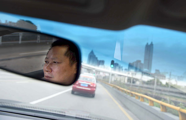 Xia Zhengwu checks messages from customers on his smartphone.Zhang Wei / For China Daily