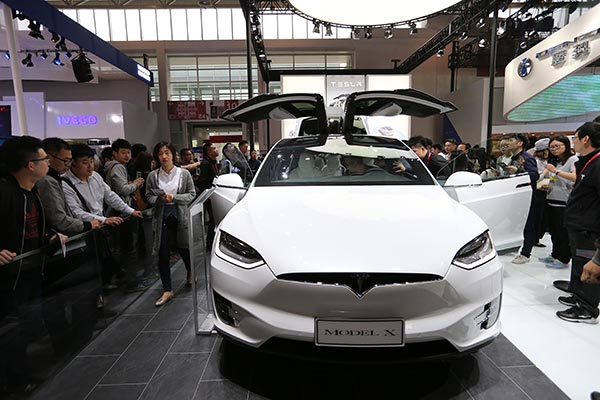 Tesla Model X attracts visitors at Auto China 2106 in Beijing, which runs through May 4. Smart and electric cars are becoming more popular in China as young customers favor greater connectivity in vehicles. WANG ZHUANGFEI / CHINA DAILY