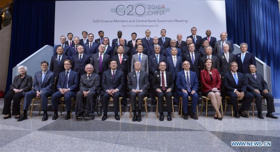 Finance ministers and central bankers of the G20 pose for a family photo after G20 meeting during the IMF and World Bank spring meetings in Washington D.C., capital of the United States, April 15, 2016.(Xinhua file photo/Yin Bogu)