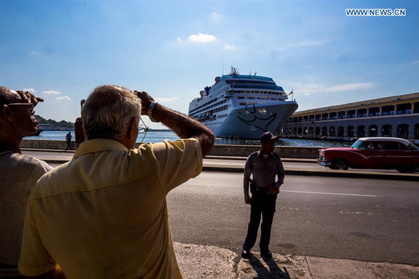 People watch the U.S. cruise ship Adonia arriving in Havana, Cuba, May 2, 2016. Carnival Corp.'s Adonia left a Miami port on Sunday afternoon and arrived in Havana Monday, with 704 passengers aboard, including several Cuba-born passengers. The last such cruise from a U.S. port to a Cuban destination happened in 1978. (Xinhua/Liu Bin)