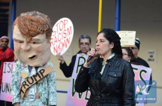 Members of the anti-war group Code Pink protest against U.S. Republican presidential candidate Donald Trump's racism words before the Trump Hotel in Washington D.C., the United States, Dec. 10, 2015. (Xinhua/Zheng Qihang)