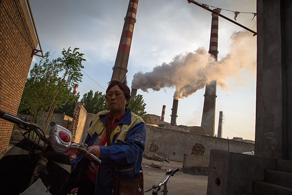A resident reacts to the air in Handan, Hebei province, in April. The city, known for its highly polluting industries, such as steel, is facing an industrial transformation.Provided To China Daily