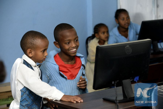 Students use a computer during a donation ceremony at Hayelom Araya Primary School in Addis Ababa, capital of Ethiopia, Jan. 6, 2016. (Photo: Xinhua/Michael Tewelde)