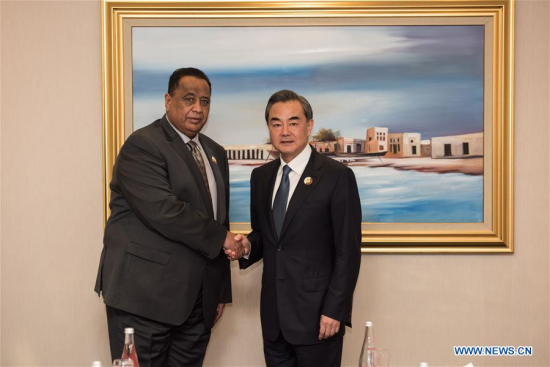 Chinese Foreign Minister Wang Yi(R) meets with Sudan's Foreign Minister Ibrahim Ghandour after the 7th ministerial conference of the China-Arab States Cooperation Forum in Doha, Qatar on May 12, 2016. (Photo: Xinhua/Meng Tao)