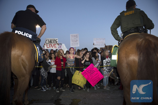 File photo: Protesters react outside a Donald Trump campaign rally in Orange County, southern California, April 28, 2016. (Photo: Xinhua/Yang Lei)