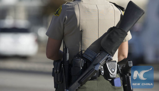 A policeman patrols near the scene of a shooting in San Bernardino City of Southern California, the United States, on Dec. 2, 2015. (Photo: Xinhua/Yang Lei)